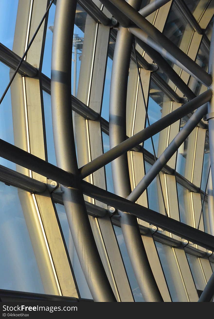 Steel beams and rods in a curved structure forms a glass facade. Steel beams and rods in a curved structure forms a glass facade