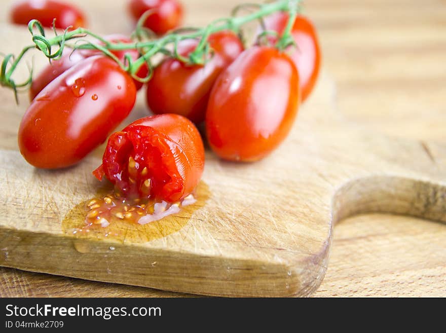 Plum tomatoes over cutting board