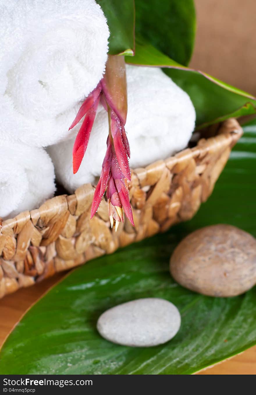 SPA. Tropical flower on a towel and stones