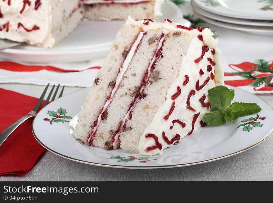 Piece of white cake on a Christmas plate. Piece of white cake on a Christmas plate