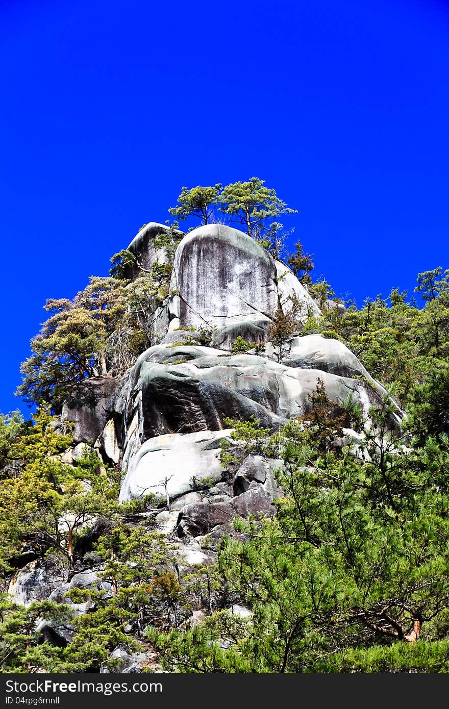 Mountain peak under bright blue sky.