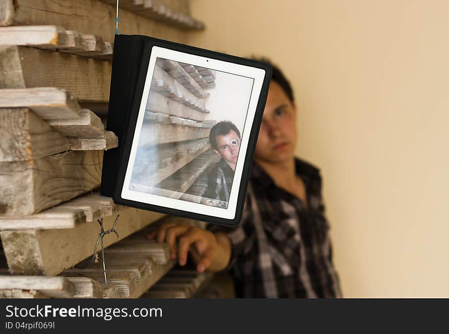 Young man showing photo on the flatbed computer. Young man showing photo on the flatbed computer