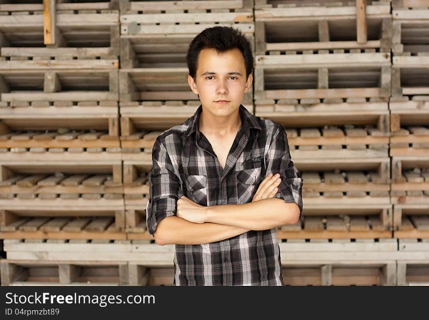 Young man stay near the boards has crossbreed hands. Young man stay near the boards has crossbreed hands