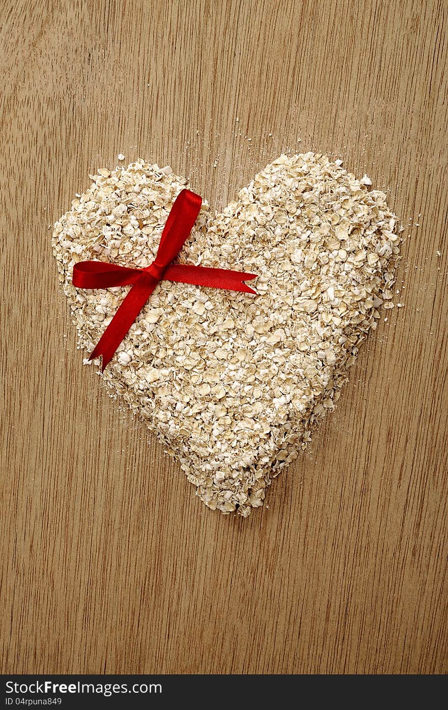 Heart shape oatmeal on wooden background. Good for healty food concept