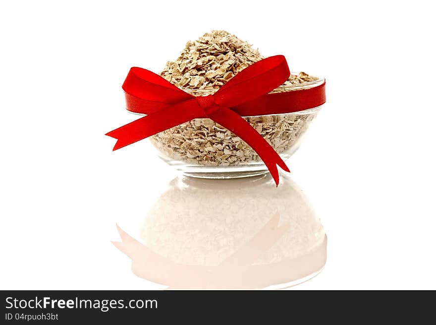 Oatmeal in glass bowl  over white background