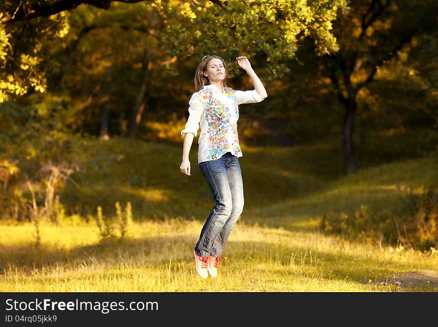 Young Pretty Woman In The Autumn Park