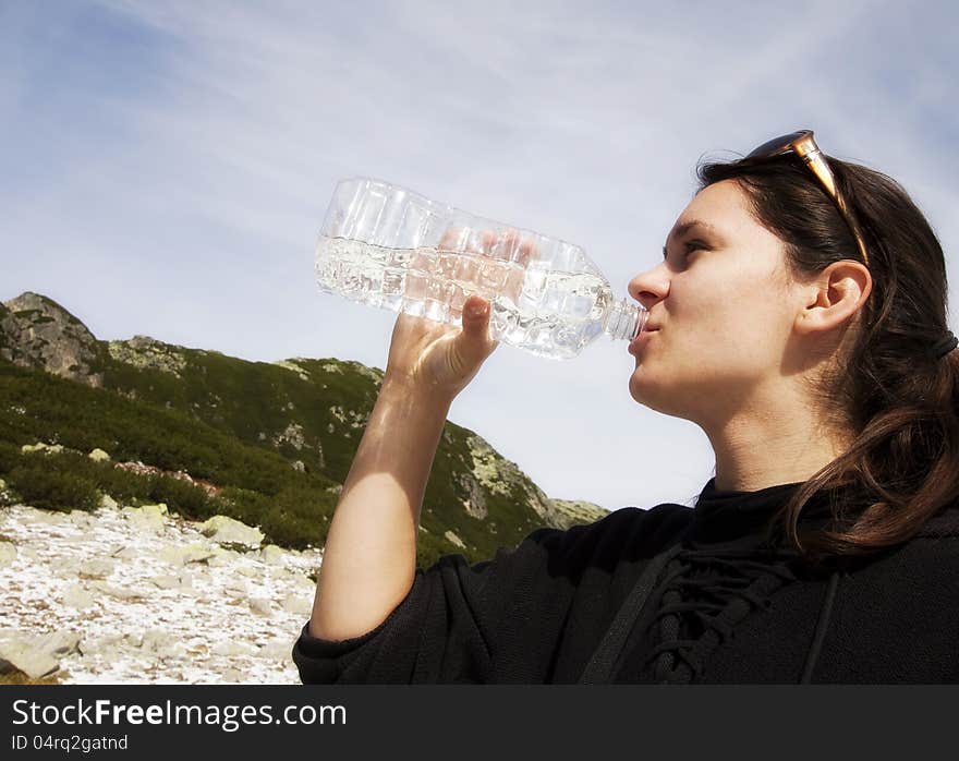 Woman drinking crystal clear water from bottle