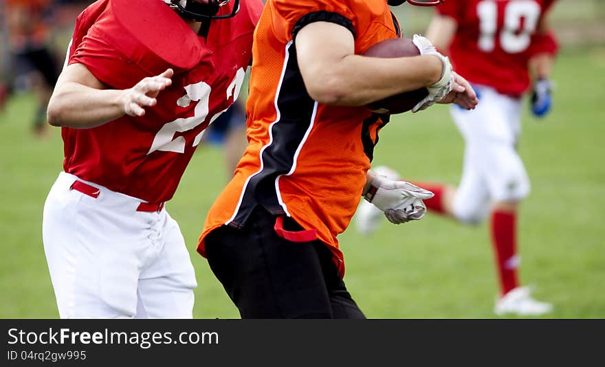 American football players fighting for the ball