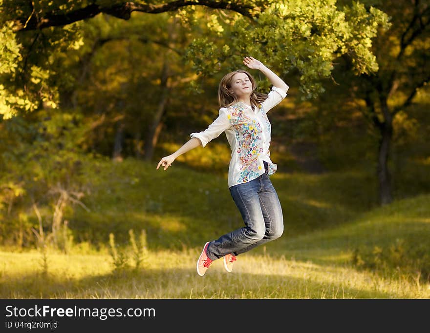 Young pretty woman jumping in the autumn park. Young pretty woman jumping in the autumn park