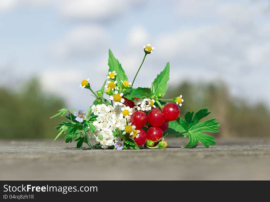 Bouquet of flowers and berries on the table