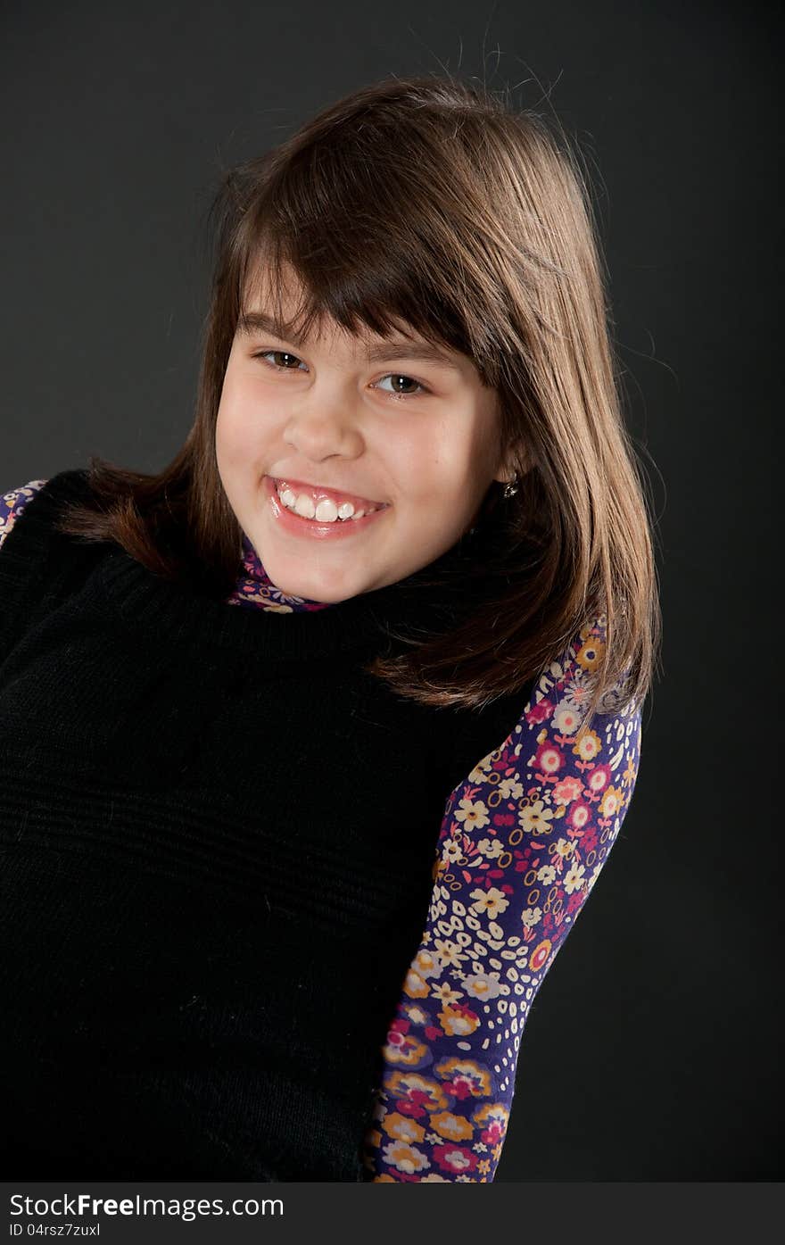 Cheerful girl smiling with a colorful dress