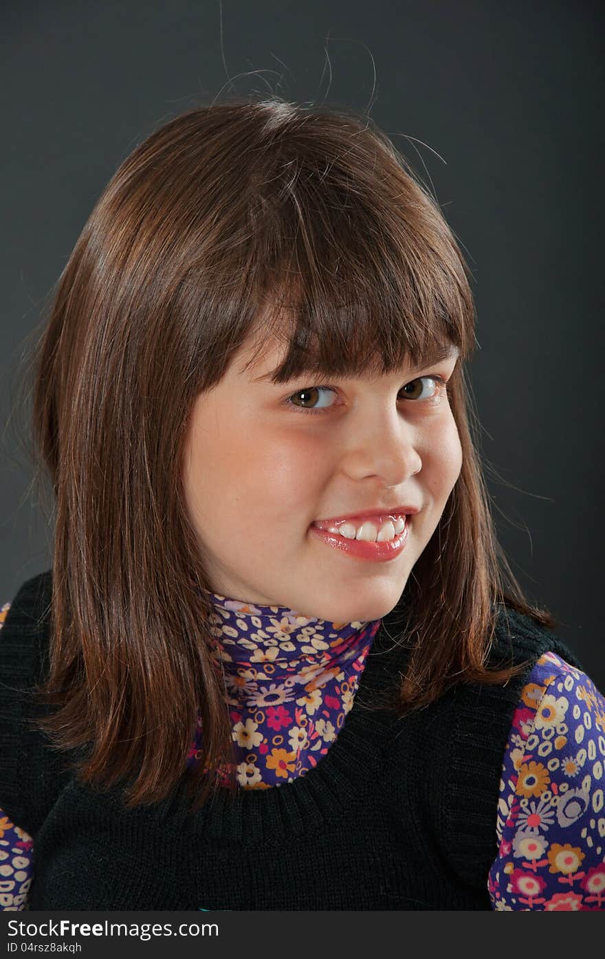 Cheerful girl smiling with a colorful dress