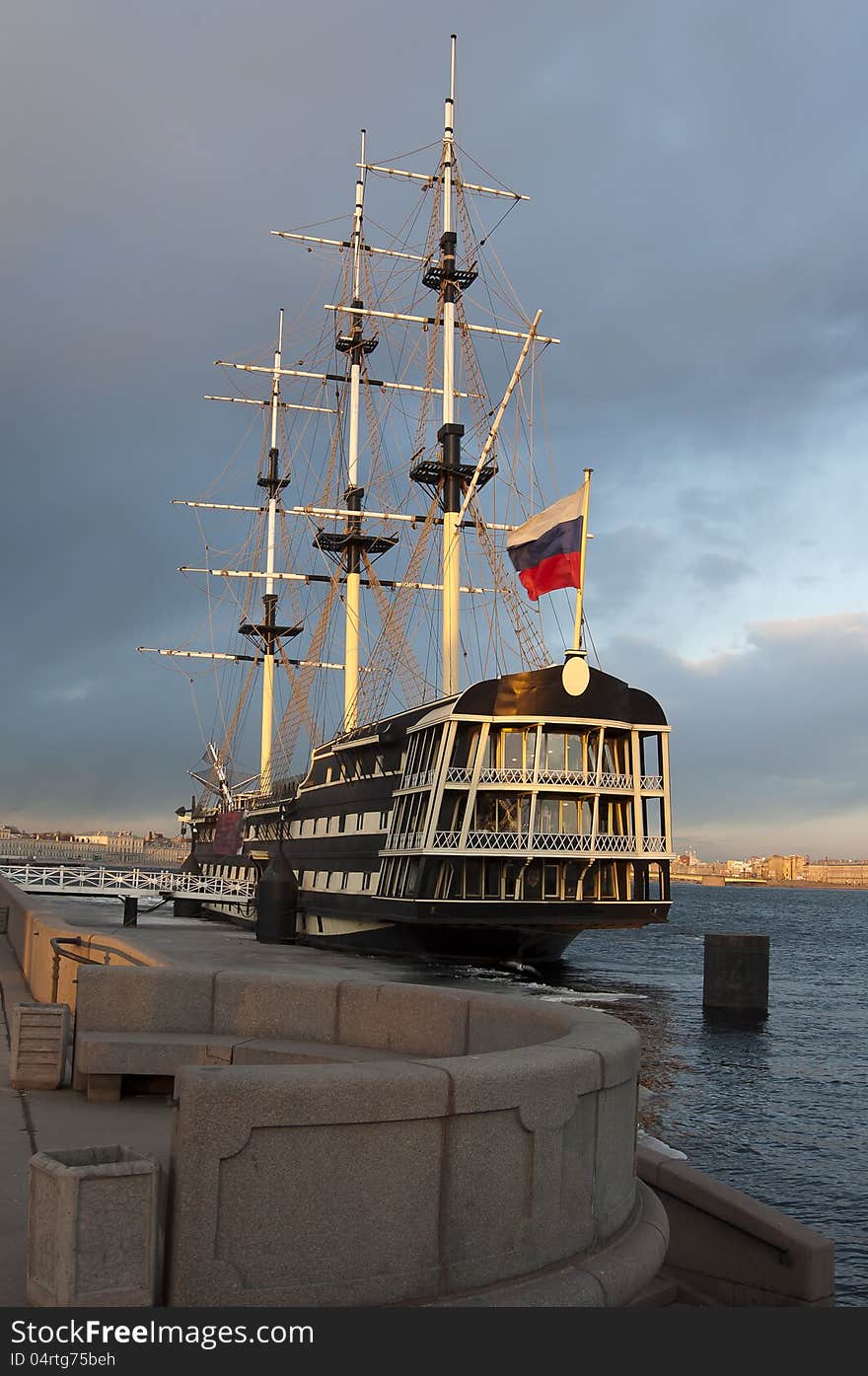 Ancient sailing vessel at granite pier on the Neva River in the city of St. Petersburg