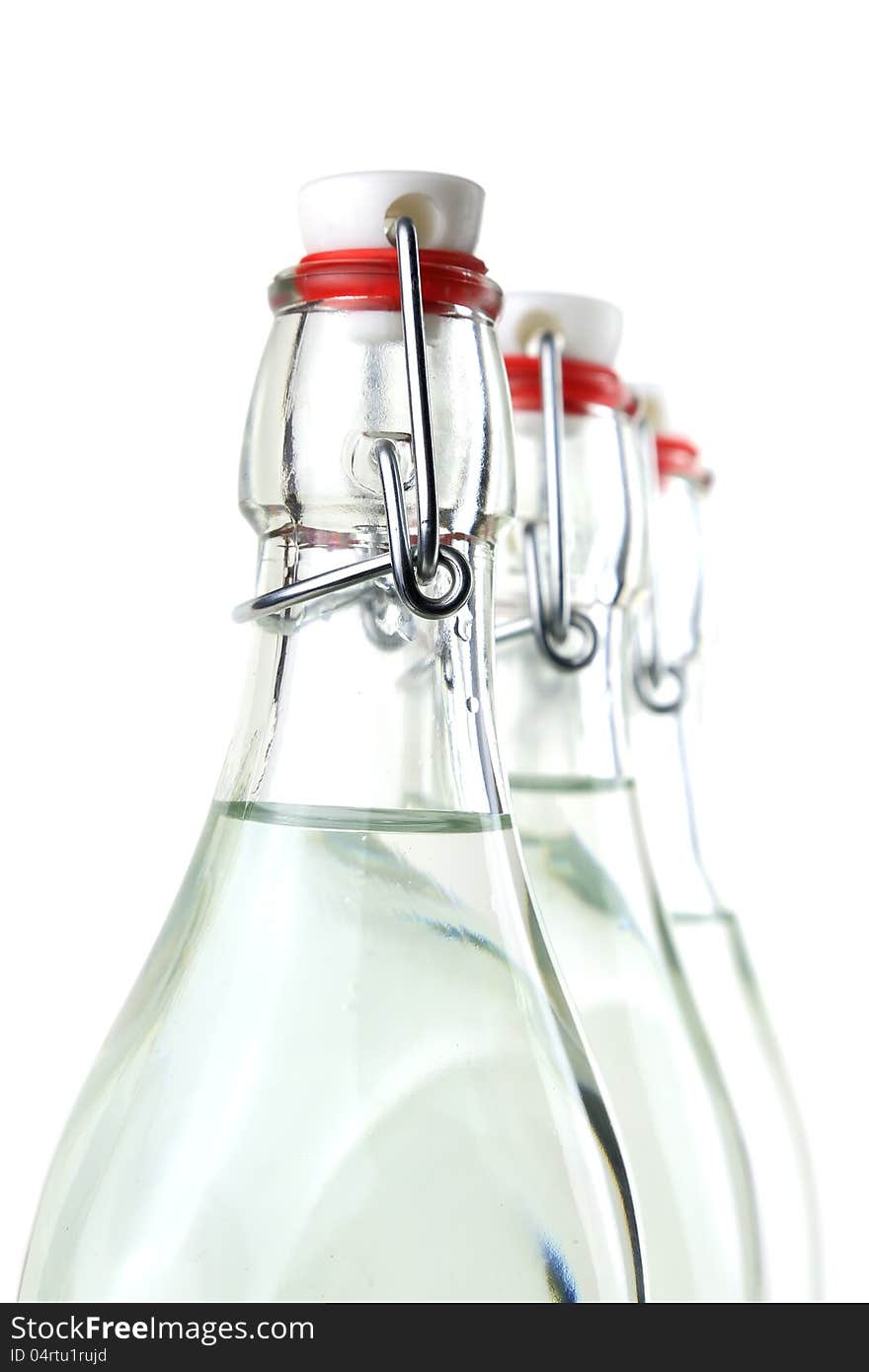 Water in three old-fashioned swing top bottles. Water in three old-fashioned swing top bottles