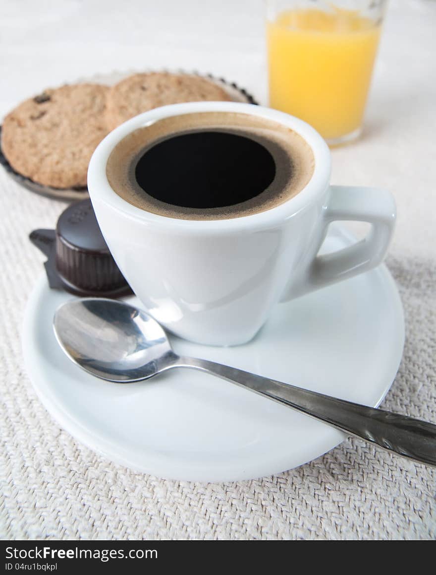 Chocolate Chip Cookies with Cup of Coffee on white fabric