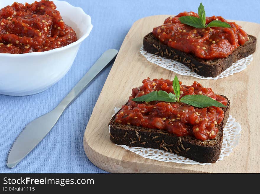 Black bread and vegetable paste on the board