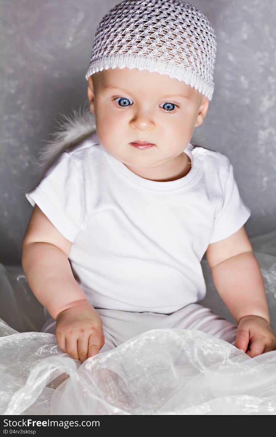 Astonished infant looking down