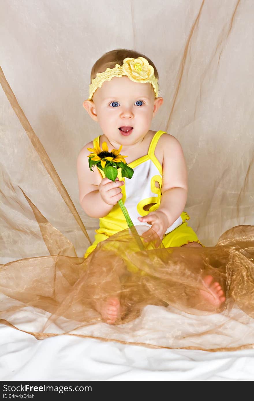 Baby smiling and holding flower. Baby smiling and holding flower