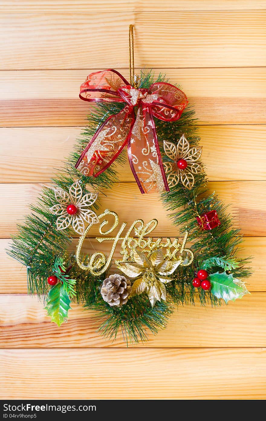 Christmas wreath hanging on a wooden wall