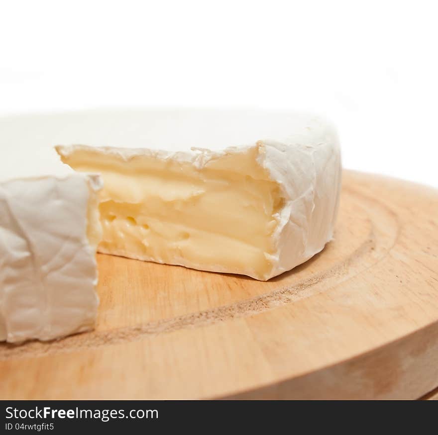 Circle Brie  Cheese On Wooden Desk Isolated