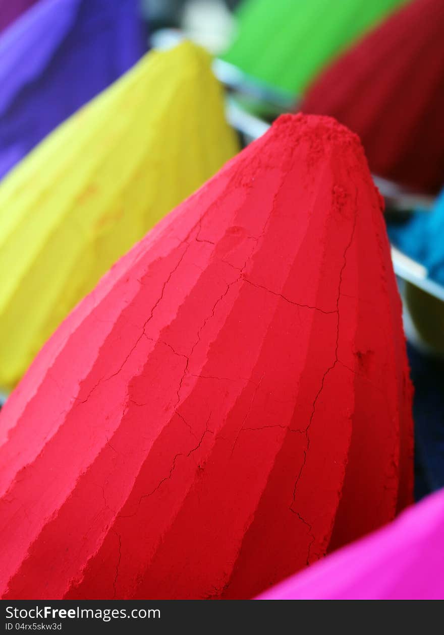 Piles and mounds of colorful dye powders for holi festival & other religious purposes being sold in indian market. The powders include kumkum(vermillion) in brilliant red, haldi in bright yellow, etc. Piles and mounds of colorful dye powders for holi festival & other religious purposes being sold in indian market. The powders include kumkum(vermillion) in brilliant red, haldi in bright yellow, etc