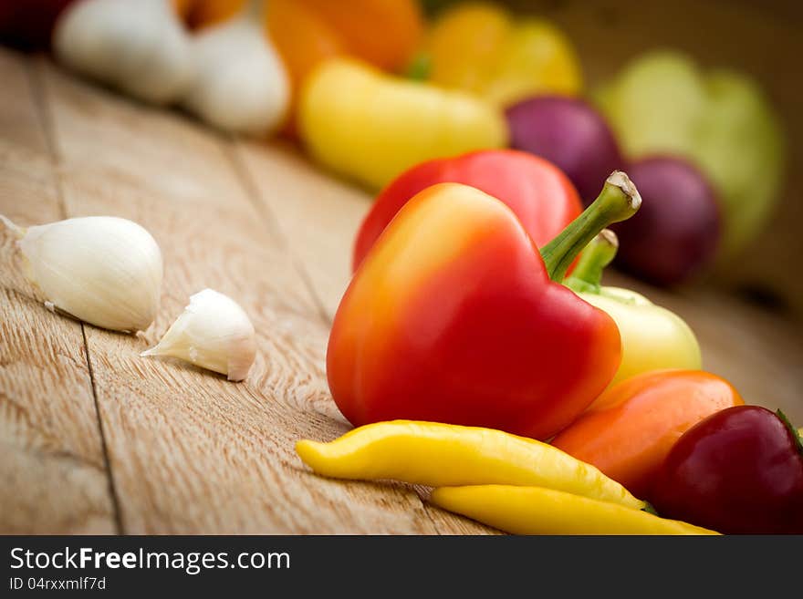 Multicolored peppers - colorful peppers on the table. Multicolored peppers - colorful peppers on the table