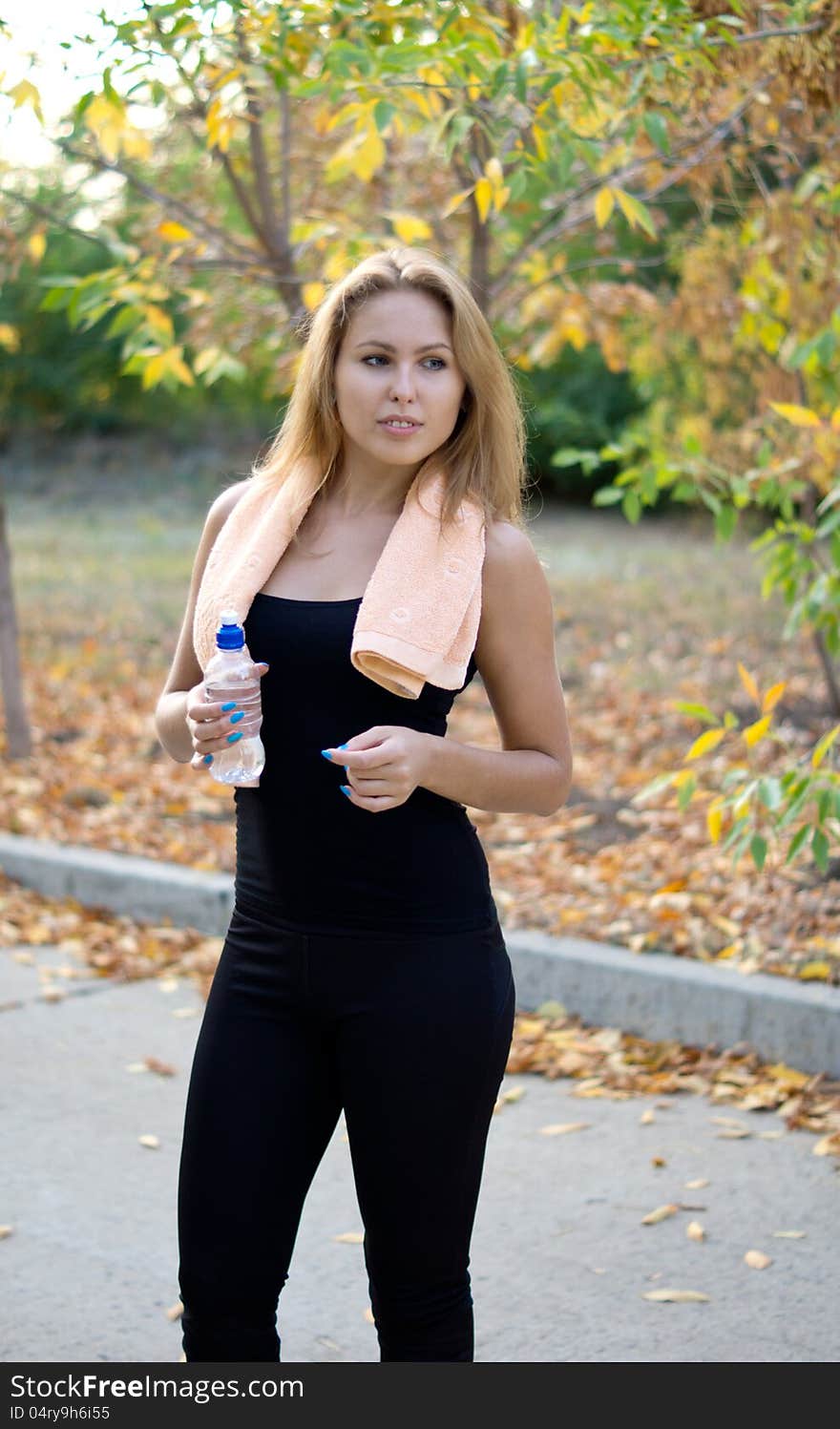 Beautiful athlete drinking water