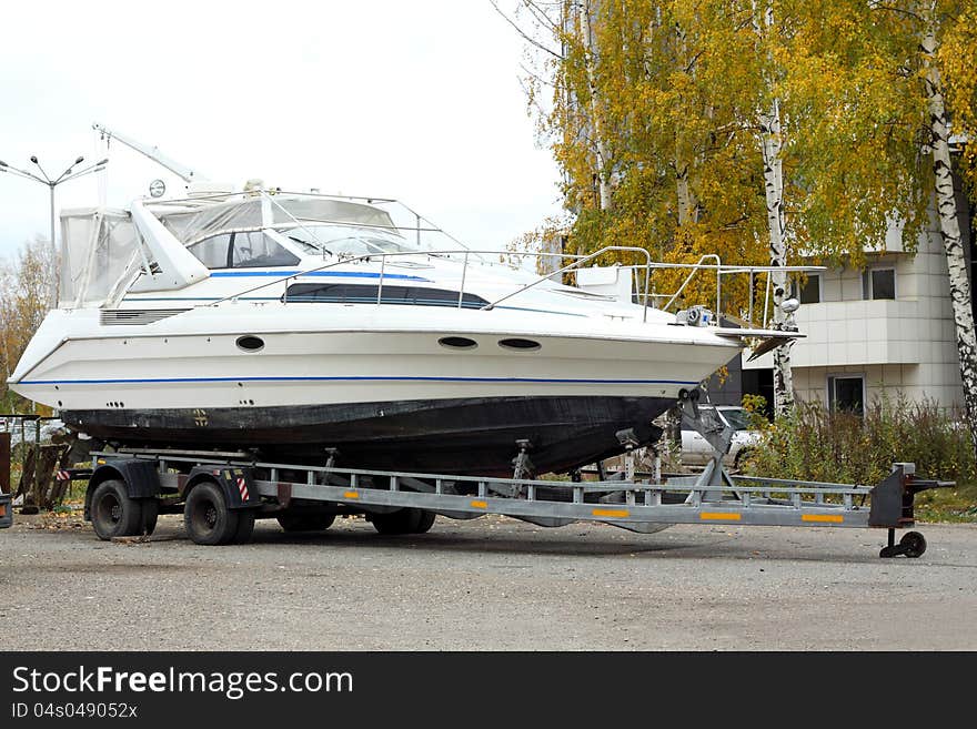 The big motor yacht is loaded on a trailer