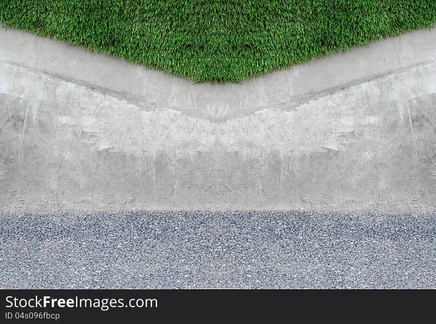 Artificial grass on a cement wall background