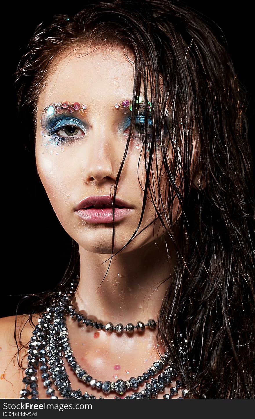 Portrait of young woman with beautiful face and wet hairs closeup