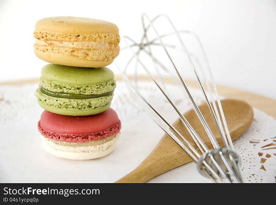 Stack of colorful macarons with kitchenware. Stack of colorful macarons with kitchenware