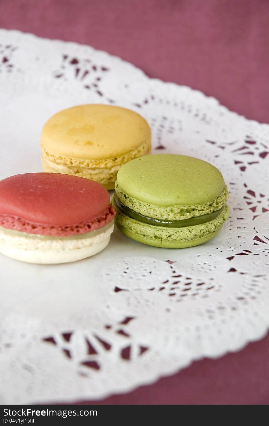 Three of french macarons on color background. Three of french macarons on color background