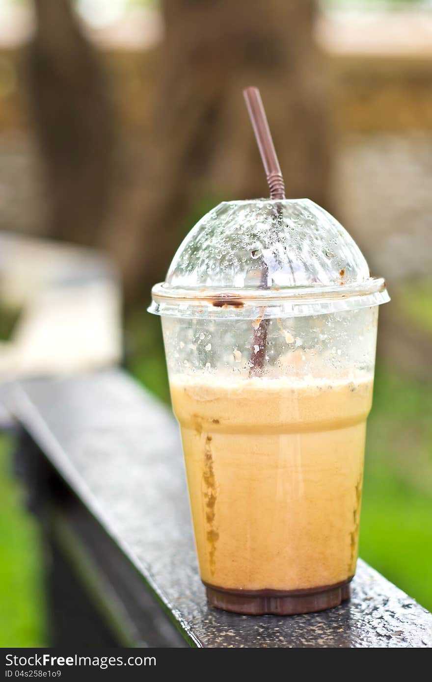 Delicious ice coffee cappuccino on wood table at outdoor. Delicious ice coffee cappuccino on wood table at outdoor