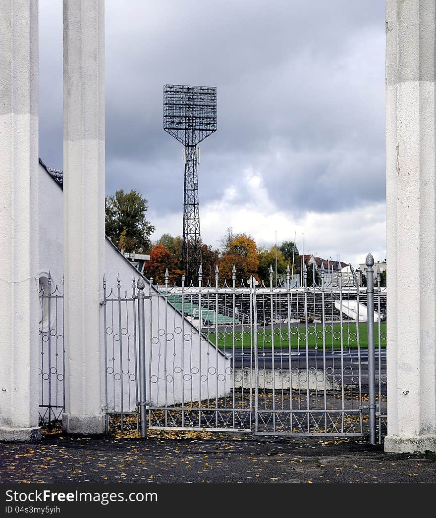 Old city sports stadium, broken fence and wall. Old city sports stadium, broken fence and wall