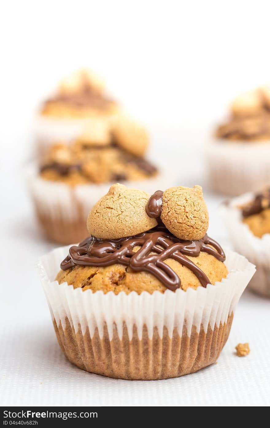 Muffin made of amarettini crumbs, amaretto and marzipan with a chocolate glaze and amarettini biscuits on top. Muffin made of amarettini crumbs, amaretto and marzipan with a chocolate glaze and amarettini biscuits on top.