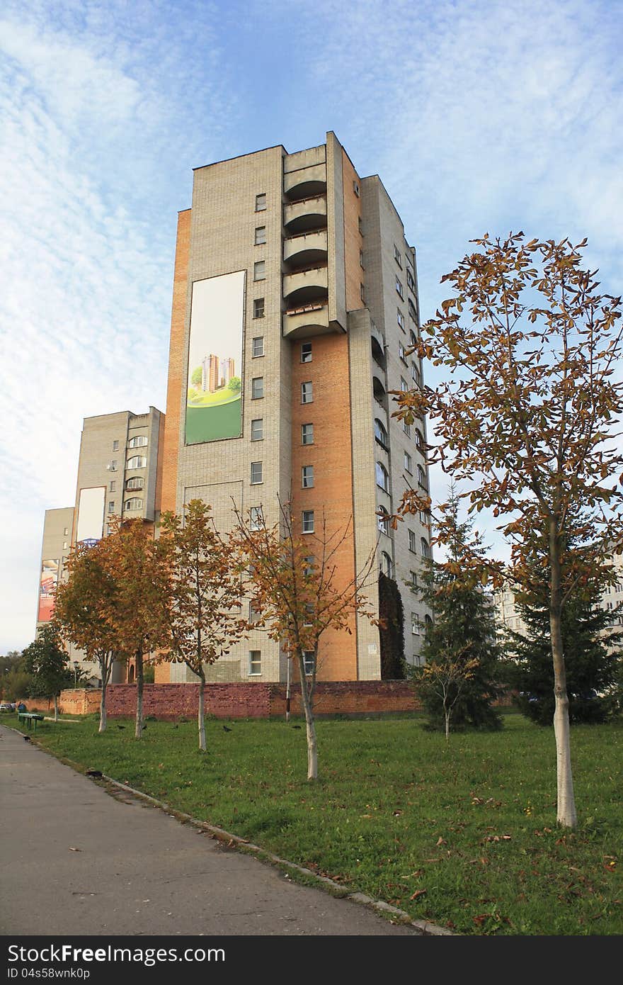 Street photo with high houses, yellow trees and green lawns in early autumn. Street photo with high houses, yellow trees and green lawns in early autumn