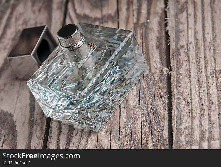 Parfume bottle on old wooden table