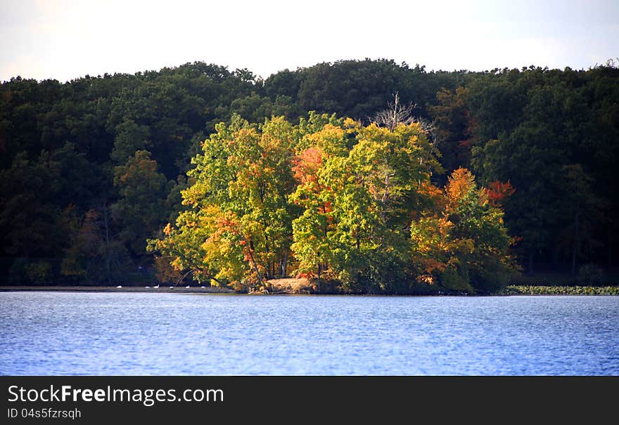 Sun rays falling on the small island in the lake