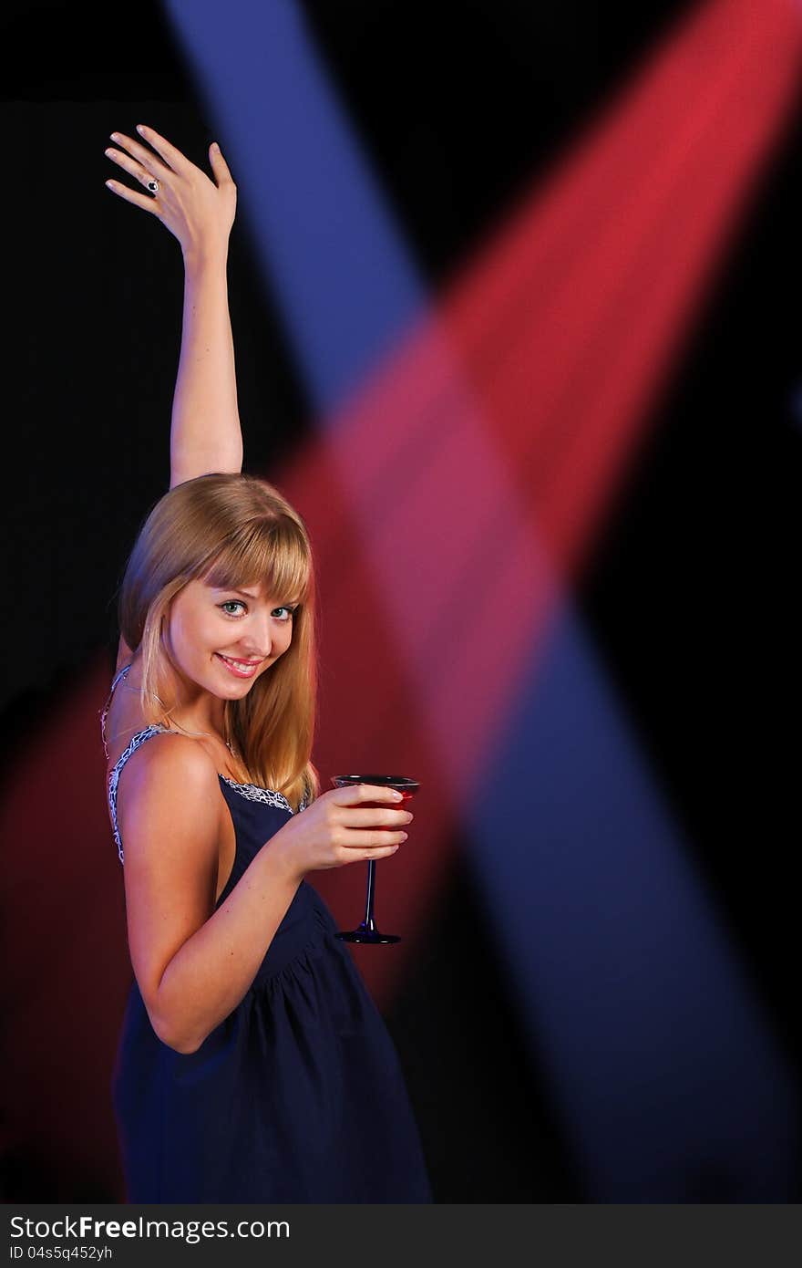 Girl with beverage on disco dancing