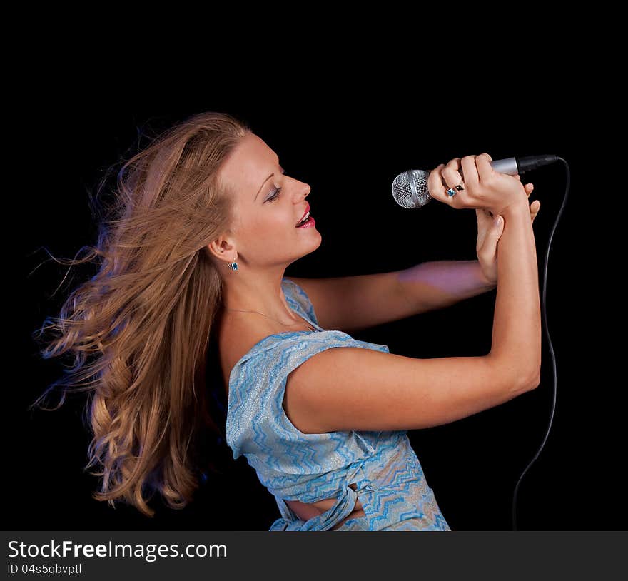 Girl singing in microphone whith pleasure