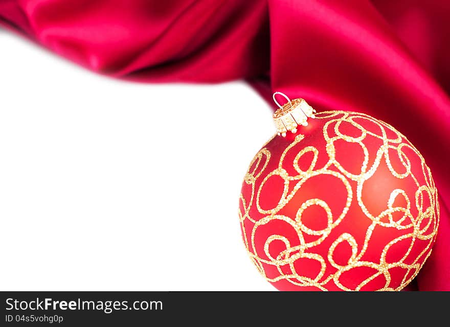 Christmas bauble and  the red silk  background. Christmas bauble and  the red silk  background