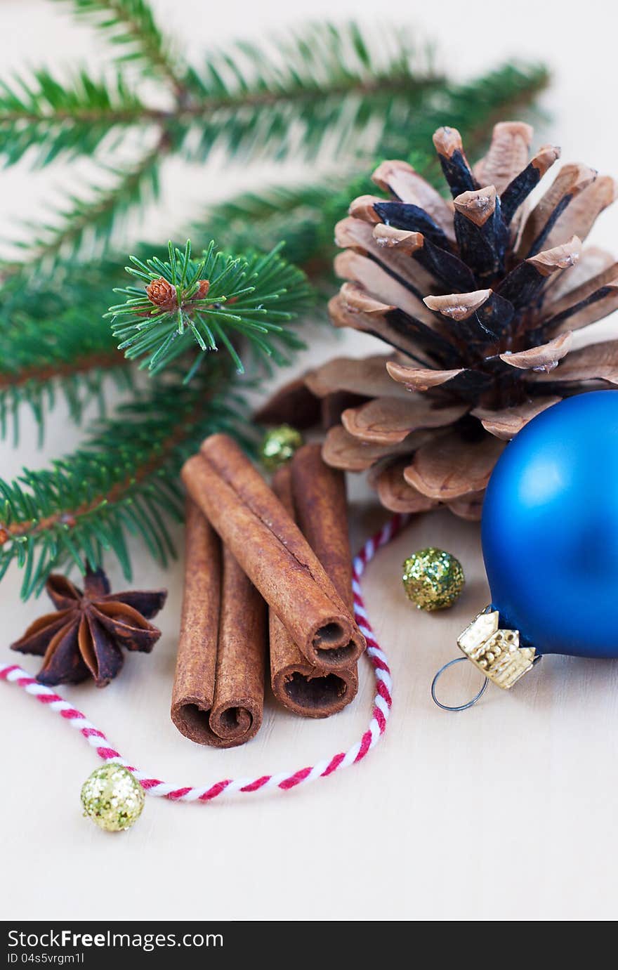 Pinecone, christmas tree with a blue bauble and cinnamon sticks. Pinecone, christmas tree with a blue bauble and cinnamon sticks.