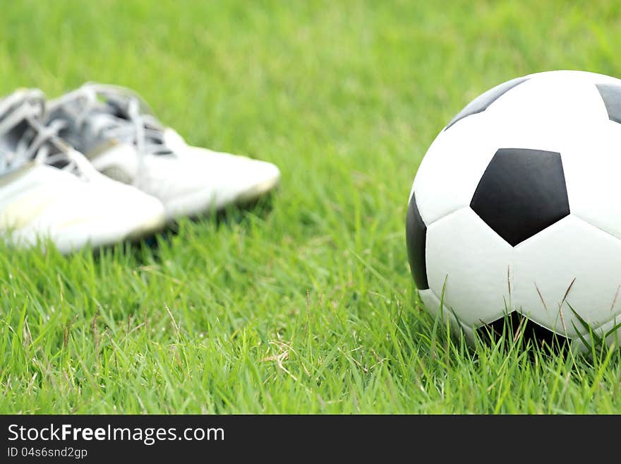 Football and soccer shoes in the field