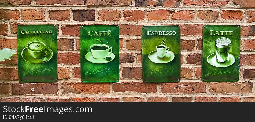 Old Coffee teasers on a brick wall