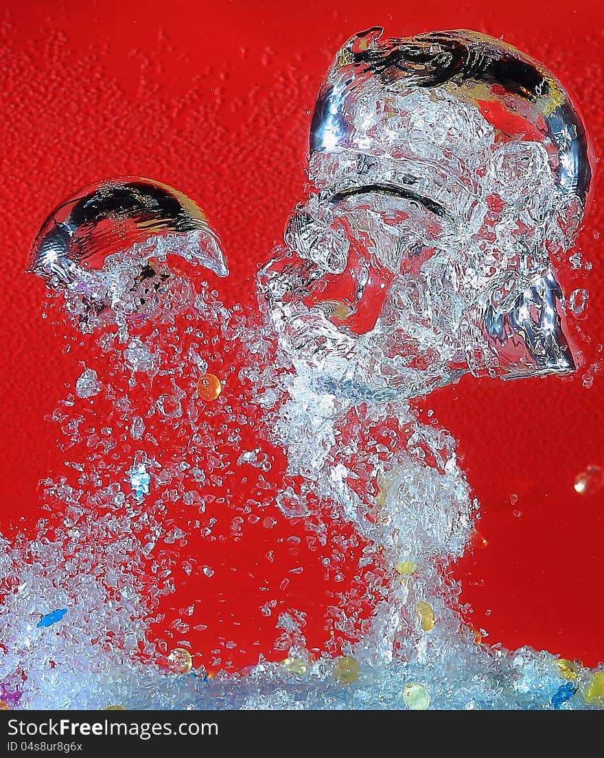 Airbubbles riising quickly and shattering in water in front of red background. Airbubbles riising quickly and shattering in water in front of red background