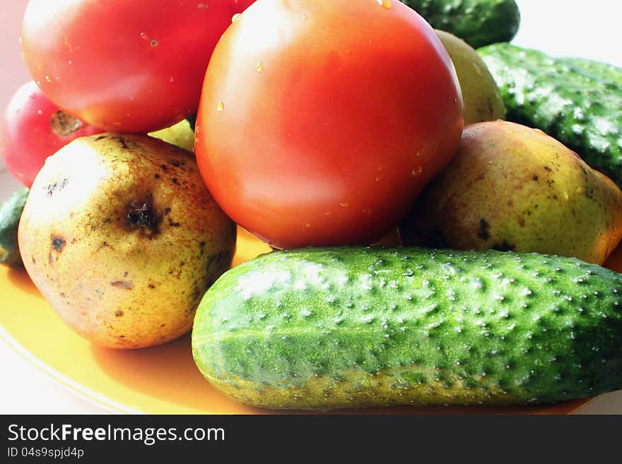 Fruits and vegetables (cucumbers, tomatoes, pear). Fruits and vegetables (cucumbers, tomatoes, pear)