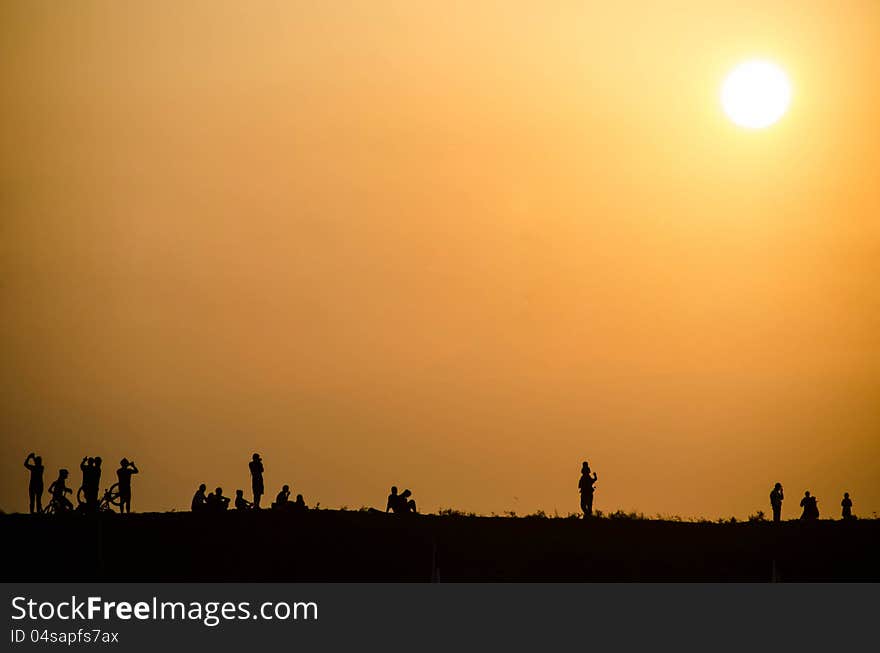 Silhouette of people at sunset on the Silhouette of people at sunset