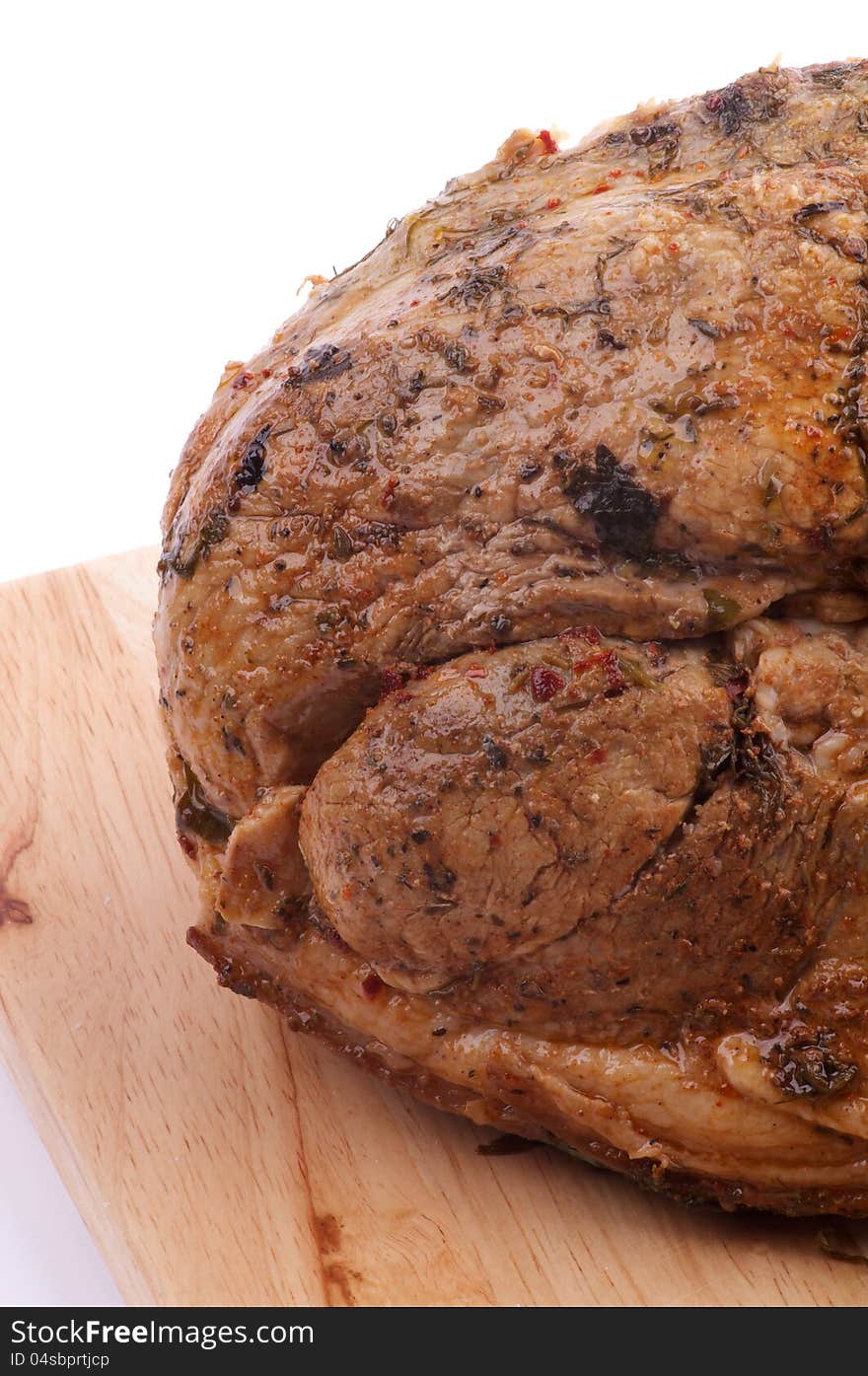 Ripe Roast Pork Tenderloin with Spicy Herbs closeup on Cutting Board