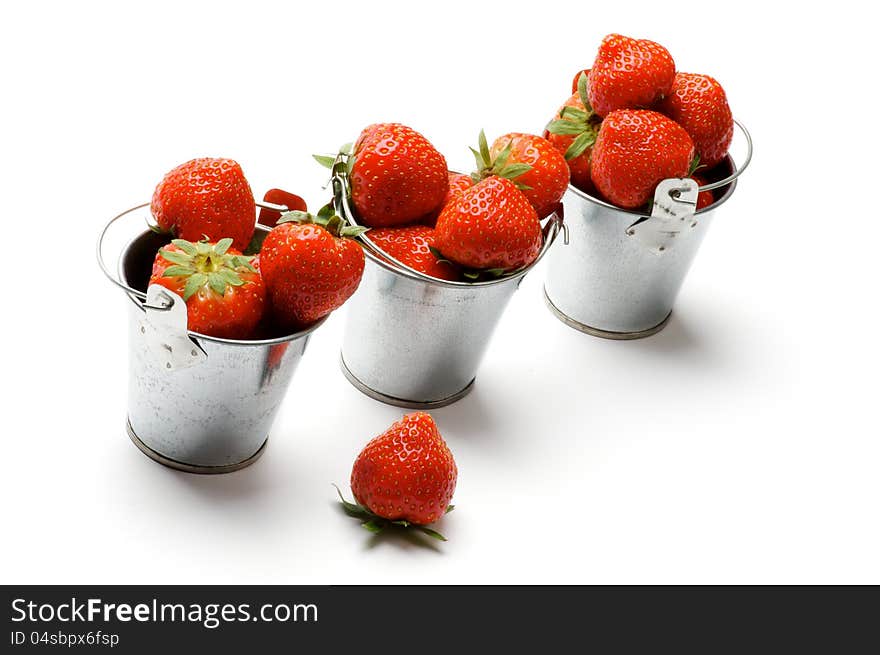 Three Tin Buckets with Perfect Ripe Strawberry in a Row on white background. Three Tin Buckets with Perfect Ripe Strawberry in a Row on white background