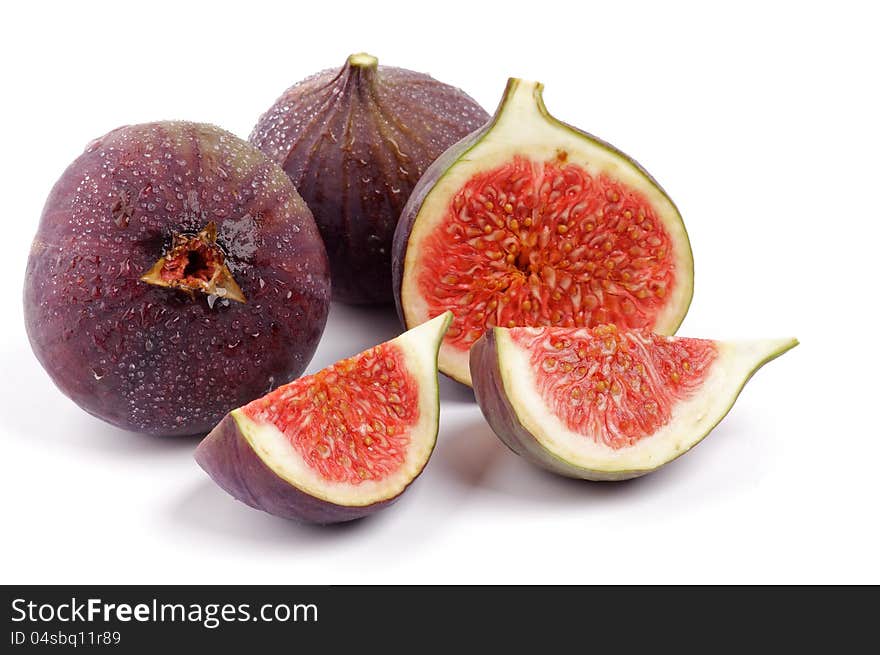 Two Perfect Ripe Figs Full Body and Slices with Droplets  on white background. Two Perfect Ripe Figs Full Body and Slices with Droplets  on white background